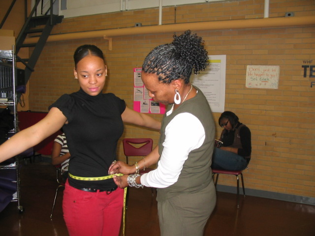 picture of Trenton Central High School student in the WHF Teen Esteem program having her waist measured by her PE Teach Ms. Kelley