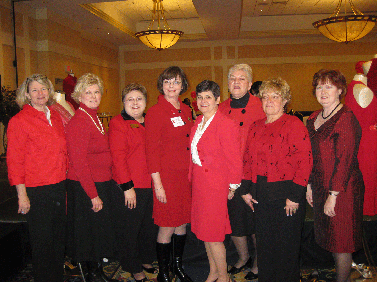 Group photo of women wearing red dresses