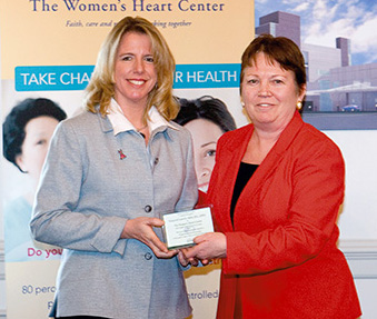 nurse Margie Latrella receives award from Bonnie Arkus