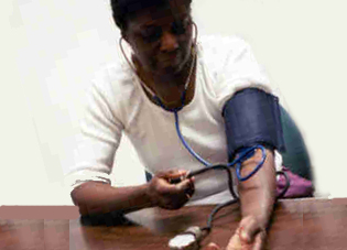 picture of African American woman taking her own blood pressure