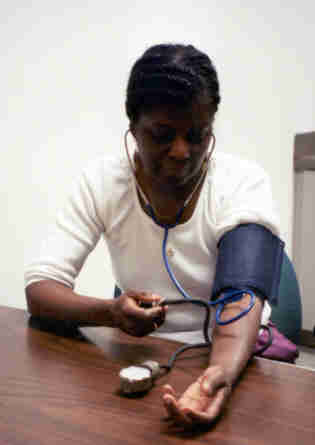 picture of the woman inflating blood pressure cuff