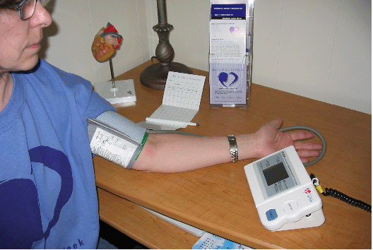 young woman with digital blood pressure device